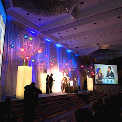 Ornamental star-shaped lights hung from bunches of white branches set on the stage of the Toy Industry Association's Toy of the Year awards at the Marriott Marquis.