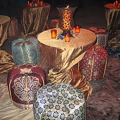 At Seeds of Peace's 'A Journey Through the Peace Market' benefit, Michal Dagan Designs decorated a courtyard area with rugs, padded brocade-covered stools, and tables with mosaic hurricane candleholders and votives.