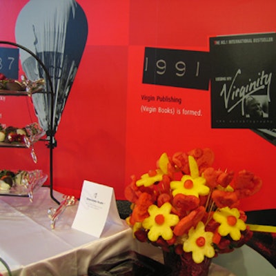 An arrangement of fruit 'flowers' accented the buffet, which was set up in front of a red wall decorated with a time line of Virgin's corporate history.