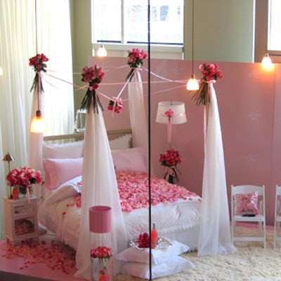 Anwar Mukhayesh, Matt Davis, and Allen Chan of HGTV's The Designer Guys decorated a bedroom vignette with rose bouquets, plastic throw pillows filled with rose petals, and loose rose petals.