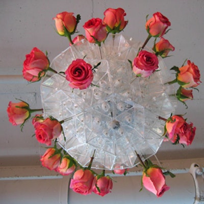An arrangement of roses embellished a custom plastic fixture hung from the ceiling.