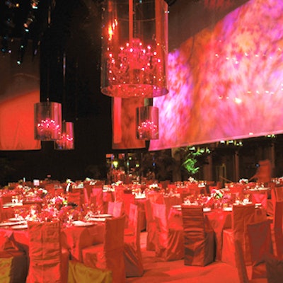 For an October automobile launch, Van Wyck & Van Wyck turned the stage at the Kodak Theatre in Los Angeles into a dining room with antique and modern touches in numerous shades of red. Bronson van Wyck covered stately Murano glass chandeliers with one-way-mirrored acetate shades. To downplay the vastness of the empty theater, a large scrim hung at the edge of the stage and showed changing projections.