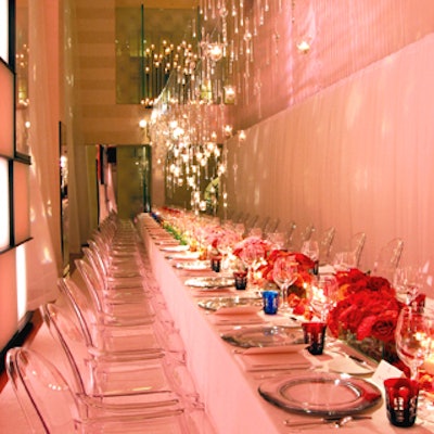 Louis Vuitton's launch dinner for its Emprise jewelry line was both colorful and restrained. David Beahm set a long table at the brand's Fifth Avenue store with rainbow-hued glasses and garden rose arrangements in deep red, pink, and cream hues. Lit softly by Bentley Meeker, the rest of the pieces were colorless or clear, and votives and tiny hand-blown glass vases filled with water hung above.