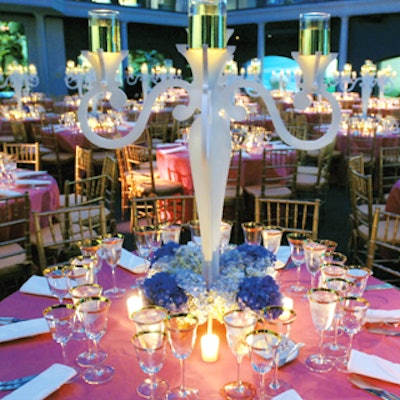 For the Avon Foundation's 50th anniversary event at the American Museum of Natural History last October, H. DeVinn Visuals designed a modern take on candelabra. At the top of the theatrical pieces were candles floating inside glasses filled with water and wrapped with gold metallic paper—a reference to the anniversary.
