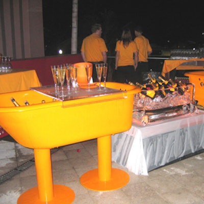 Architect Facundo Poj refinished antique bathtubs in orange and converted them into bars for chilling champagne bottles.