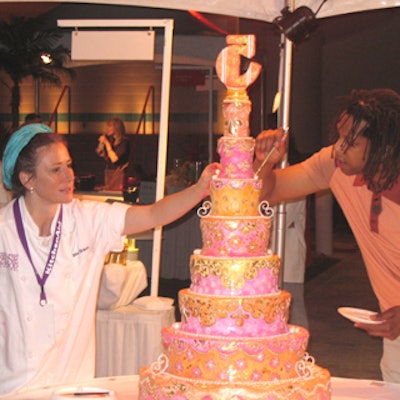 Warren Brown, the host of Food Network's Sugar Rush, helped Margaret Braun put the finishing touches on the festival's fifth anniversary cake.