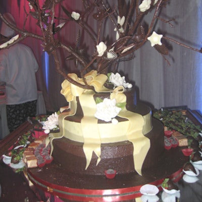 A tree made of sugar and chocolate enhanced the display of cakes, pastries, and chocolate-dipped fruit.