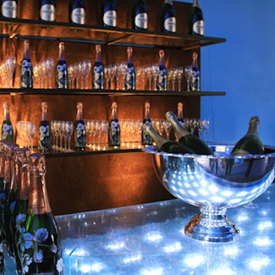 Perrier Jouët champagne flowed at clear Lucite bars, lit from within in blue.