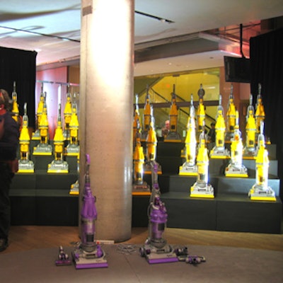 A large display with four levels of shelving featured about two dozen Dyson vacuums.