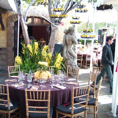 Tables were covered in chocolate faux suede and topped with amber-colored, bilevel flower arrangements of roses with hydrangea and orchids at the base.