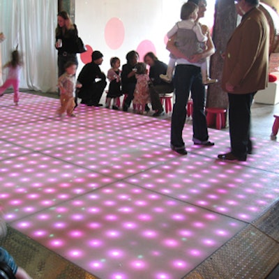 A raised, pink-lit dance floor from Visual FX was a decor focal point.