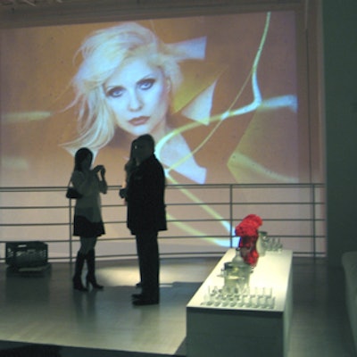 Enormous projection of Debbie Harry photos played over the railing of the upstairs space at Stephen Weiss Studio during a party celebrating Blondie's induction into the Rock and Roll Hall of Fame.