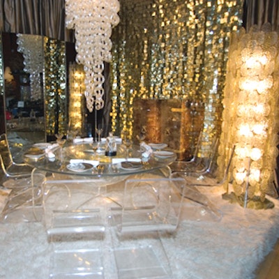 Todd Merrill showcased the modern antiques sold in his downtown shop with a lush, over-the-top setting with mid- and late-70's furnishings. To fit with one of the dinner's sponsors, French vodka Jean-Marc XO, Merrill chose all European pieces, including a French Lucite table with a fishbowl in the center. The Toso chandelier had 750 glass links that had to be individually wrapped and linked before the event.