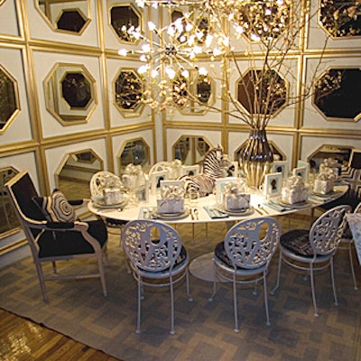 To showcase its work, framing products company Larson-Juhl brought in Jonathan Adler, who put walls of framed, octagon-shaped mirrors behind a table topped with his china and accompanied by framed silhouettes set as place cards. Our favorite touch: the contrast of tall cherry blossoms with sputnik-shaped chandeliers.