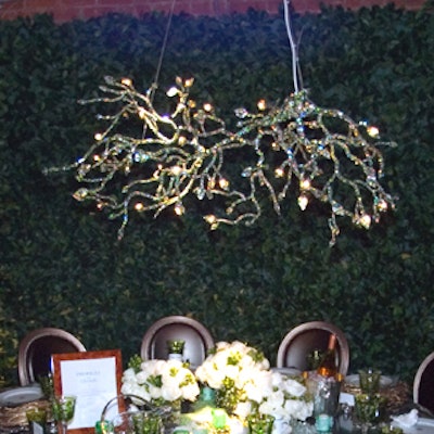 The Profiles for Christofle table was based on a concept by Shannon Shapiro, who created an outdoor look with leafy hedges on three sides, a chandelier resembling tree branches, and place mats that resembled birds nests underneath the plates.