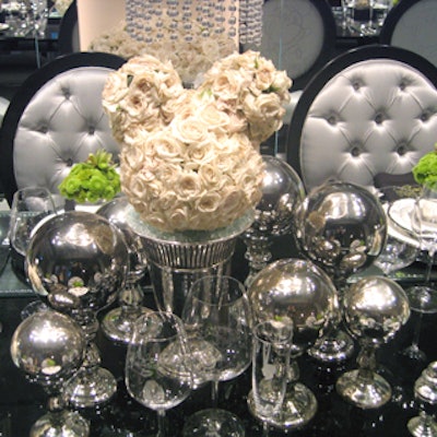 Silver groupings covered the Walt Disney Signature table, showing off the brand's future line of tabletop wares. Clusters of shiny gazing balls were arranged on the table along with flower arrangements in the trademark shape of Mickey Mouse's head.
