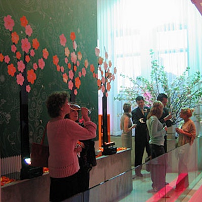 A garden area on the second level displayed more metal trees, and orange ribbons printed with the Veuve logo filled the planters below.