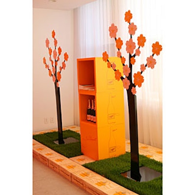 In the entry hallway, cutout metal trees stood amid patches of wheatgrass surrounded by Champagne crates.
