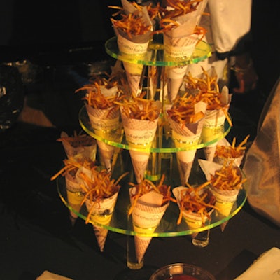 Eatertainment displayed frites in paper cones on a three-tiered green acrylic serving tray.