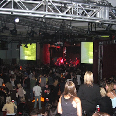 The two screens, located on both sides of the stage, ran images of guests, the fashion show, the New York Dolls performance, and the karaoke performance.