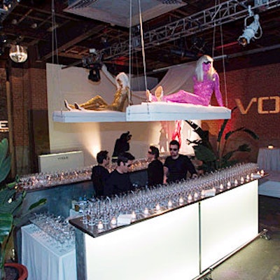 Over the bar, models lounged on swings hung from the ceiling.