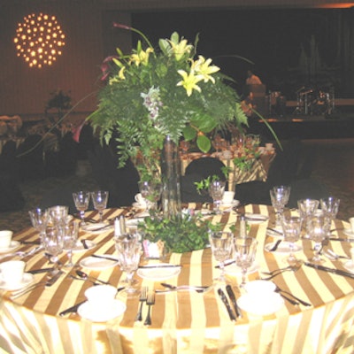 Beautiful fruit and floral centerpieces highlight the gold striped table dressings in perfect Venetian flavor.