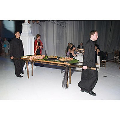 The dessert course commenced as a procession of caterwaiters entered the dining room carrying sedan tables laden with pomegranate molasses-laced watermelon cubes, almond macaroons, mini nut pastries, and baklava.