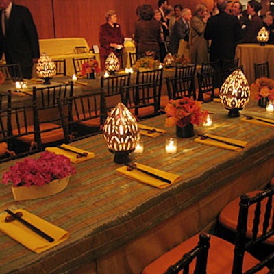 Candles, citrus-colored bouquets of flora, and egg-shaped lanterns borrowed from William's wife Katharine Rayner-who collected them during her travels in Cambodia-decorated long banquet tables topped with sunflower yellow tablecloths and lime green- and yellow-striped organza overlays.