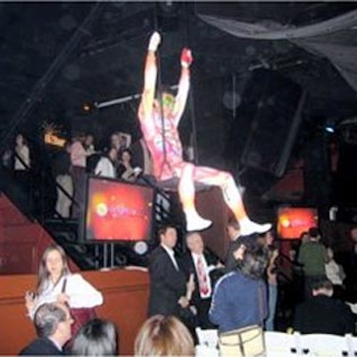 Boys on large swings hovered over the heads of arriving guests on the main floor of Pacha.