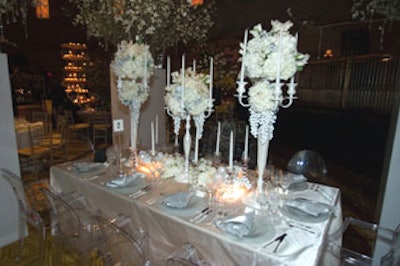 Van Vliet & Trap's table was hemmed in by four massive white pedestals topped with displays of white dogwood blossom branches and strands of sparkling crystals. The look mixed modern and Renaissance touches and included candelabra painted in metallic white, as well as accents of clear modern glass objects and metallic white fruit.