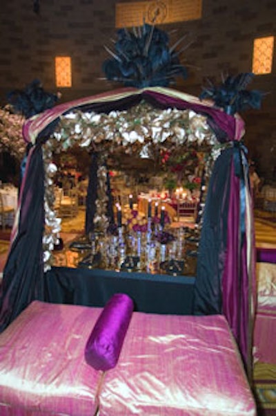 Antony Todd created a regal campaign tent setting, mixing classic and modern elements. Black-burgundy taffeta and dark plum and tangerine dupioni silks covered the tent and accompanying lounge seating. Pheasant feathers adorned the top and corners of the structure.