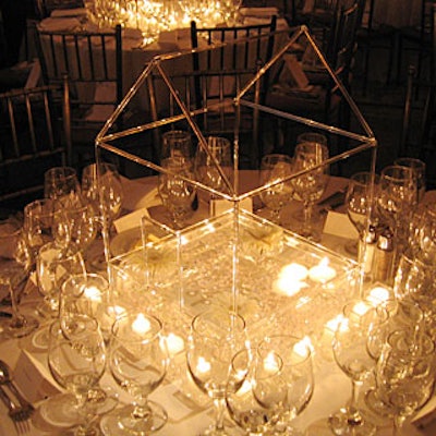 Wolfgang Thom's simple design had a glass frame, votives, and floating white gerbera daisies and candles.