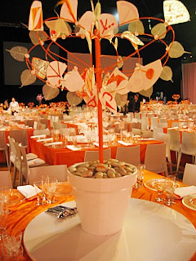 The spine of the topiaries was created from umbrellas, and each centerpiece was potted in white and orange pots containing river rocks that bore words like 'compassion,' 'attention,' and 'love.'