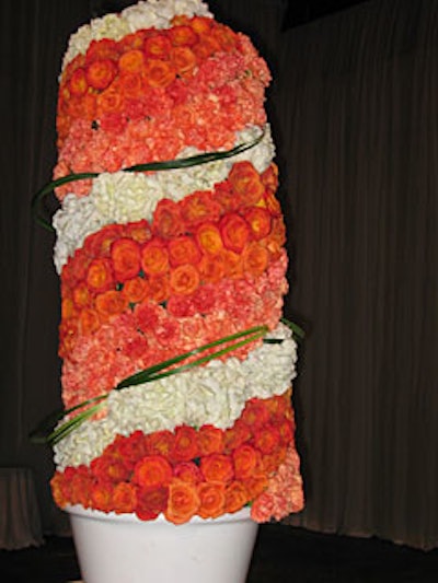 The cocktail reception featured two floral columns made up of daisies, carnations, roses, and hydrangea that flanked the room's focal point?a plexiglass-encased floral sphere.