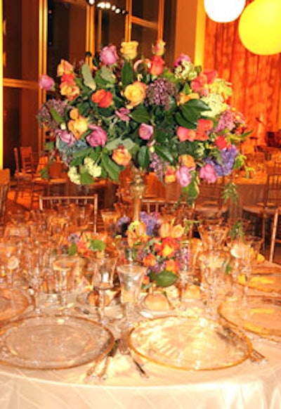 Flowers were arranged in vessels of varying heights, such as a golden three-foot-high vase with a candlestick base.