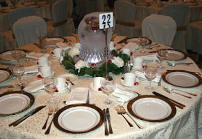 Centerpieces were domes ice with floating hearts inside that were uplit with LED lighting; white mums, ivy, and dark-chocolate hearts surrounded the ice domes.