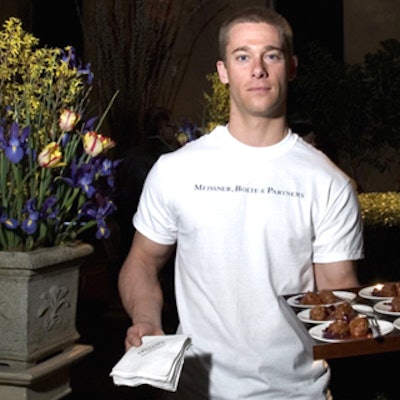 Servers from Opulence Catering wearing T-shirts imprinted with 'Meissner Bolte & Partners' passed hors d'oeuvres such as Bavarian meatballs.