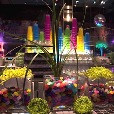 Eden Planning provided floral arrangements featuring wild green blooms in glass vases filled with coloured jelly beans.