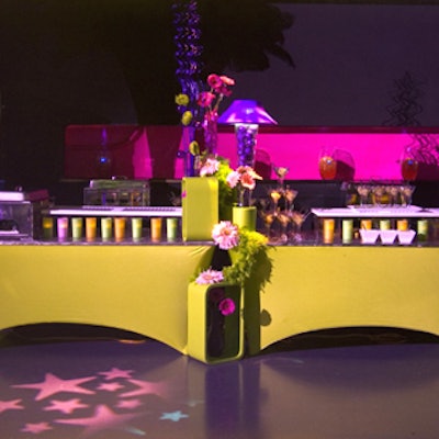 Eden Planning supplied buffet stations with vibrant hues and raised food platforms suggesting a circus theme.