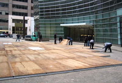 Before PTG Event Services' large tent went up, crews began installing flooring over the courtyard at One Beacon Court.