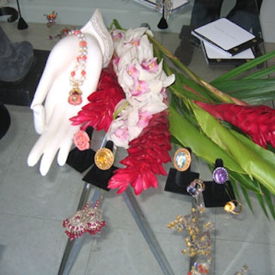 Hand sculptures, nestled with fresh exotic flowers, showed off necklaces.