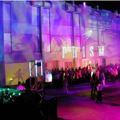 The parking lot of the PRISM sales center was transformed by logos, projections, and blasts of color by ACT Productions.
