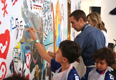 In the Federated Department Stores Foundation-sponsored art room, artist Jeff Koons painted murals on white canvas with children.