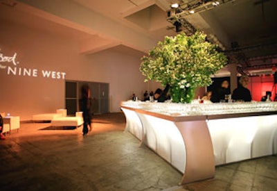 Keiko Sato designed the large floral centerpieces with mock orange branches and white hydrangeas that graced the event's bars.