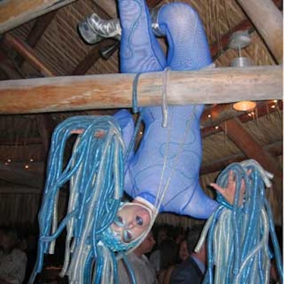 A performer from CircX hanged from the beamed ceiling of the outdoor bar.