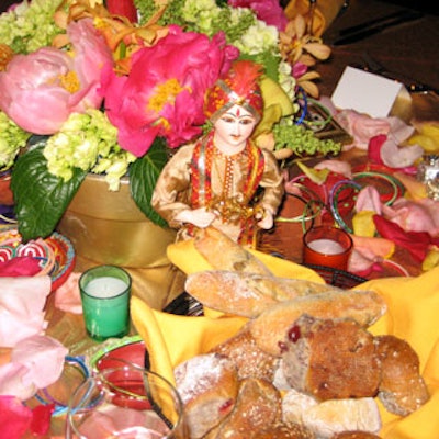 Flower petals and Indian-style bric-a-brac including statuettes, vases, and jewelry lavished tabletops. Bangle bracelets that peppered the tables also served as napkin rings.