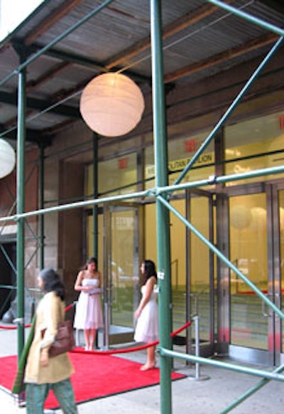 Large illuminated lanterns dressed up the entryway to the event, where scaffolding covered the sidewalk.