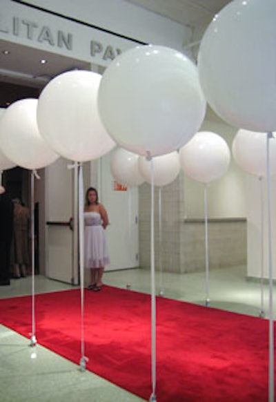 Rows of large, stationary white balloons attached to rigid ribbons and weighted down by silver stars—a play on the museum’s other current exhibition “White on White (and a Little Gray)”—lined the red carpet.