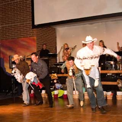 The 'live' rodeo, which ended the night, involved key donors riding toy horses.