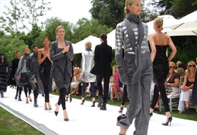 MaxMara models walked a long runway flanked by two dining tables.